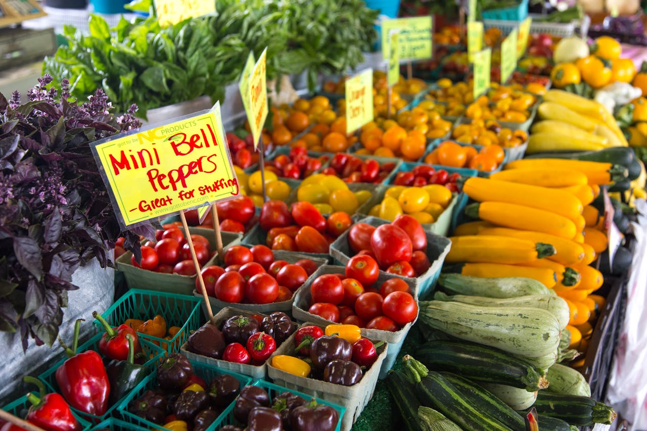 Colorful assortment of fresh vegetables at an outdoor farmers market in North Carolina.