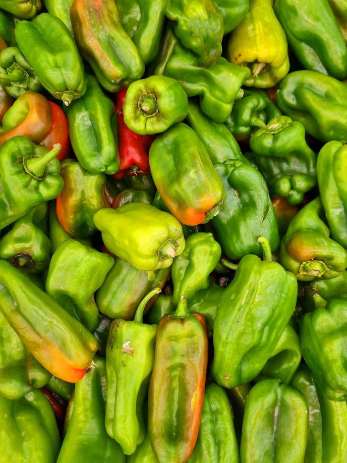 Close-up of vibrant green bell peppers at a market in Brasil.